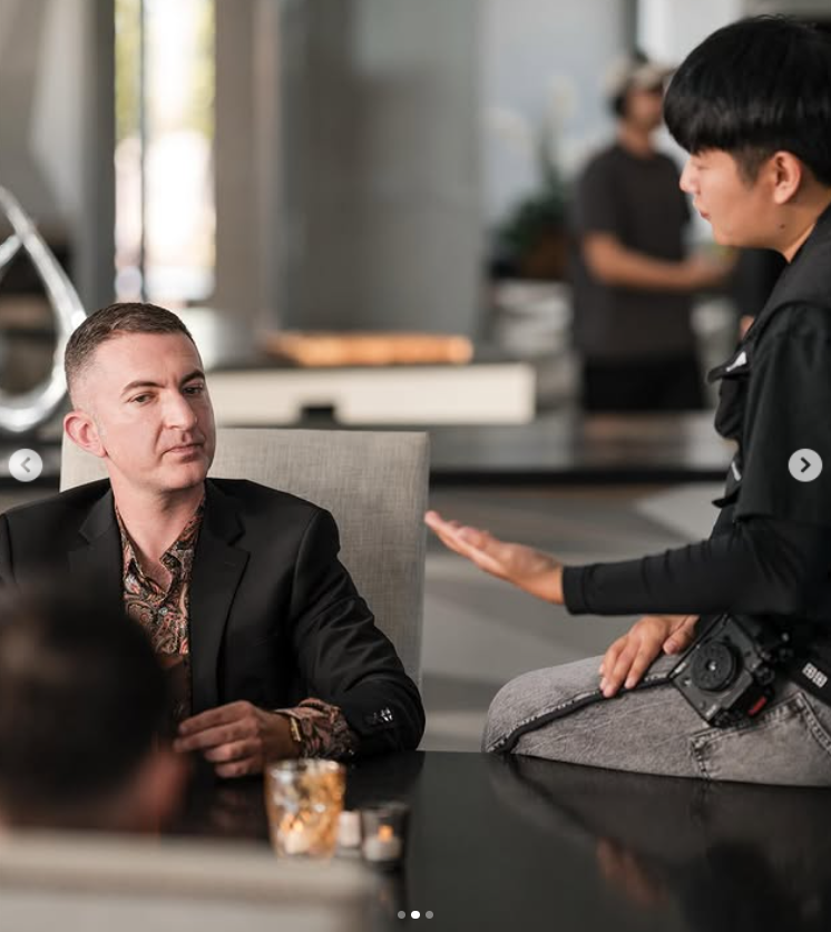 Adam Chisnall listens intently during a production discussion, mid-shoot, as posted on October 26, 2025 | Source: Instagram/theadamchisnall