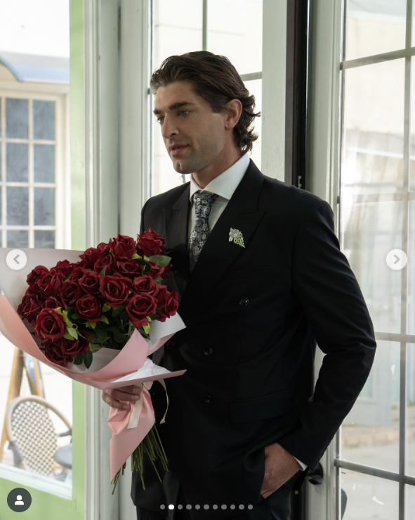 Griffin Blazi on set as Ethan, roses in hand, filming a pivotal romantic scene, as posted on July 8, 2025 | Source: Instagram/dramabox_us
